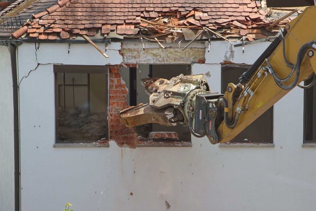Demolition of an old building with a crusher excavator