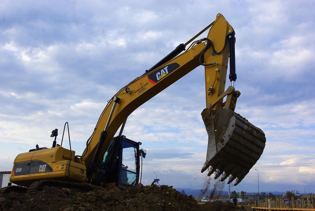Tracked excavator moving soil on a construction site